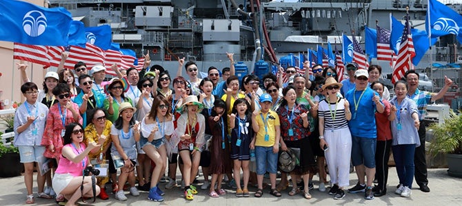 Greater China Nu Skin Sales Leaders pose for a picture in front of the USS Missouri Battleship on Ford Island.